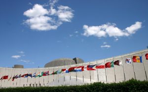 United Nations headquarters building in New York USA with the Flags of Nations in front.