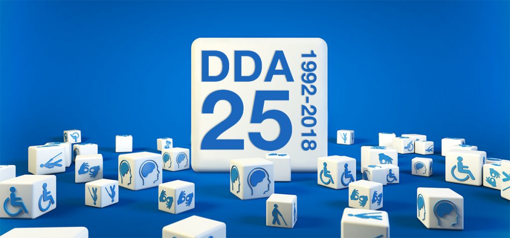 White cubes scattered around an oversize cube against a blue background. Each small cube has a different disability access symbol on it. The large cube has the letters DDA and 25 printed on it in large type. 1992-2018 is arranged vertically next to DDA 25.